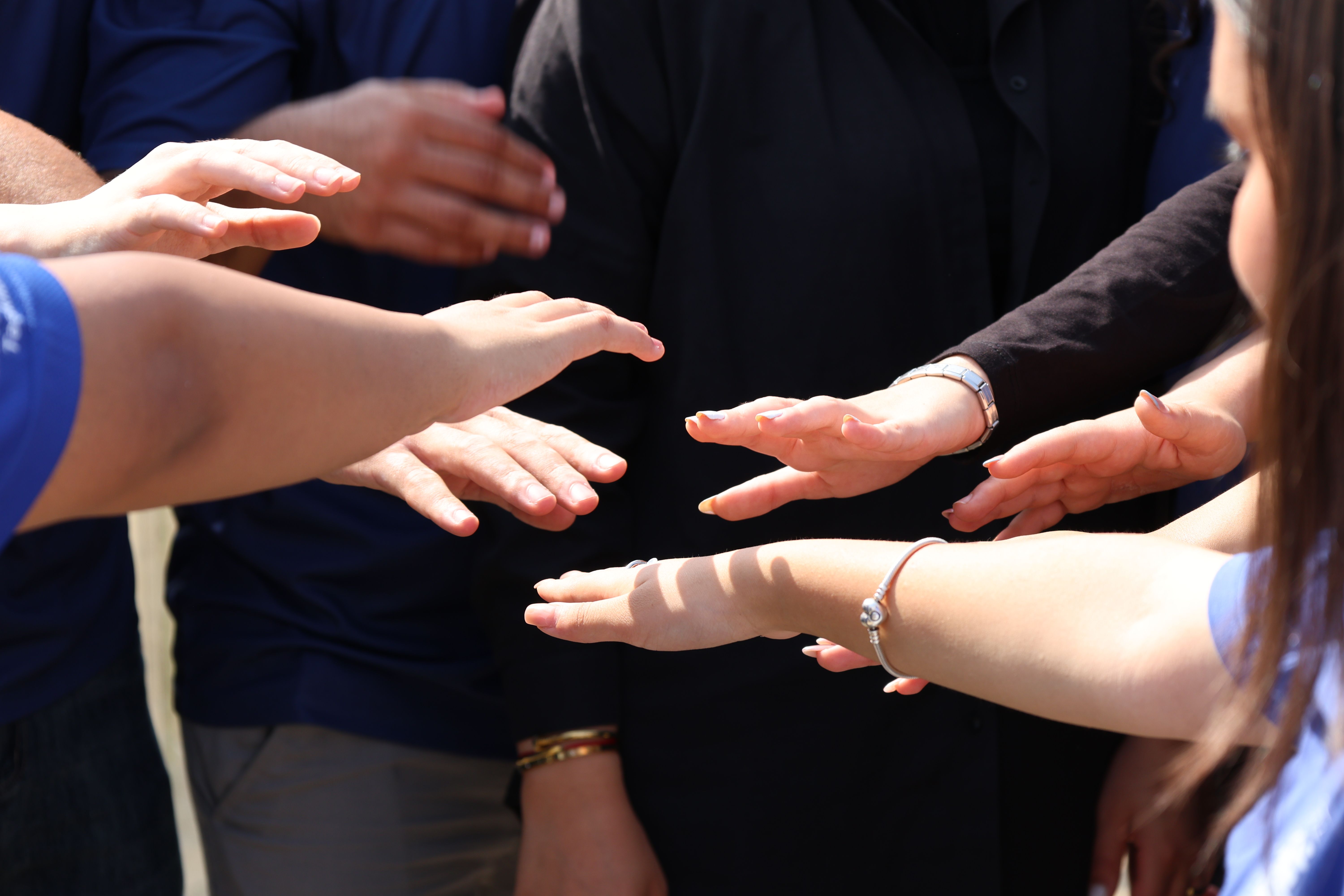 Hands reaching together in partnership