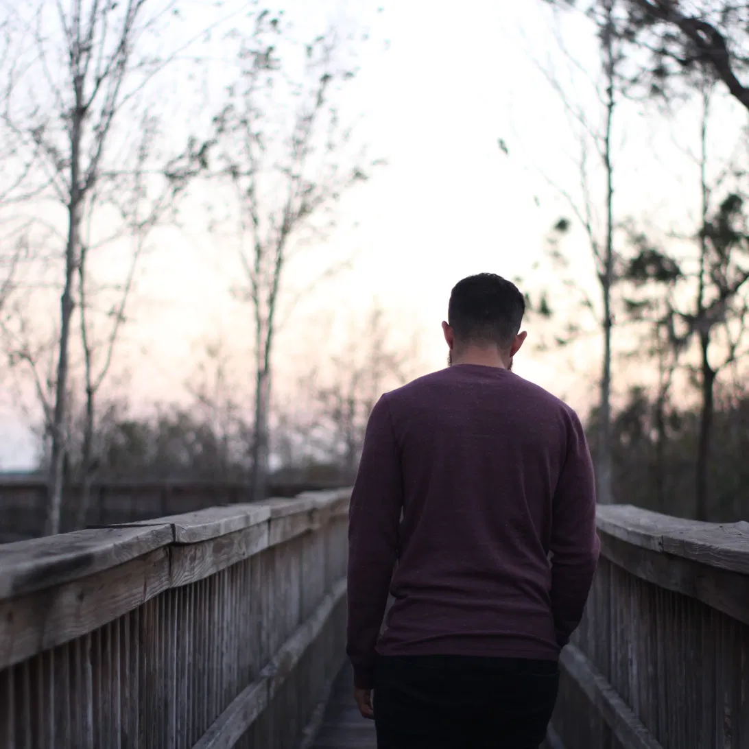 Man walking on a bridge toward a new beginning